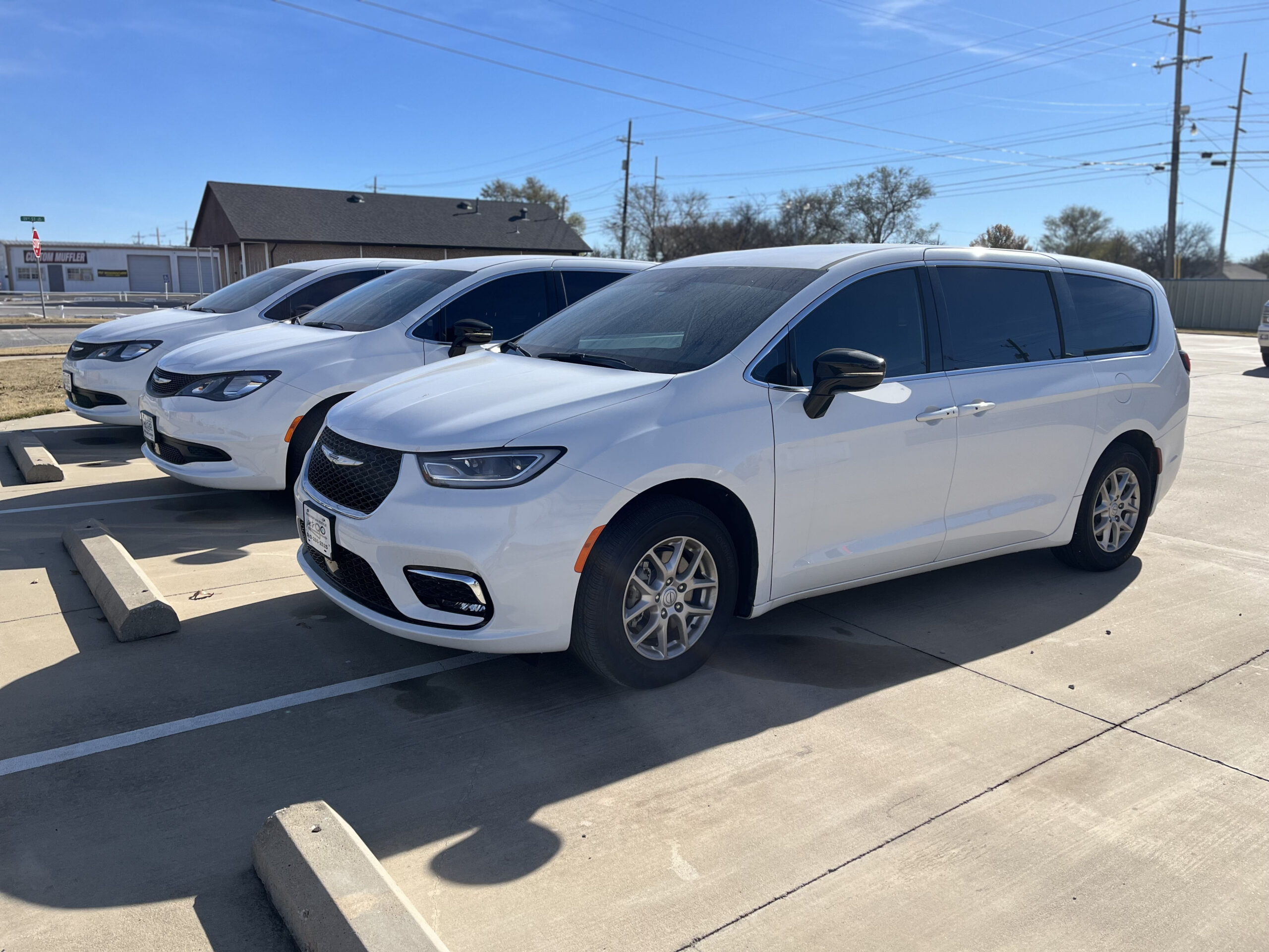 White minivans parked in a parking lot